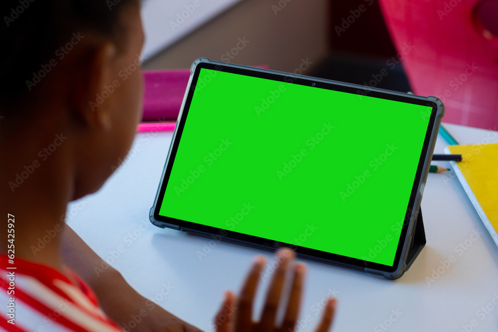 Wall mural African american boy studying online over digital tablet on table at home