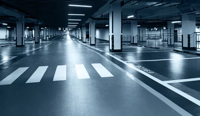 Fototapeten Empty underground parking lot in modern building. © xy