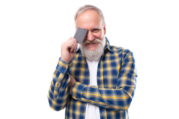 handsome 60s middle aged gray-haired man with a beard holding a plastic card on a white background