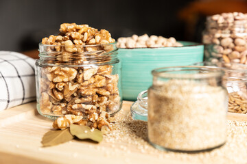 small jar with mixed nuts on rustic table top view. Healthy food and snack.