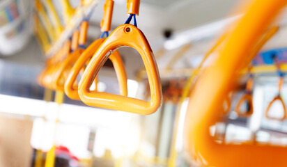 Close up of yellow handrail ring for standing passenger inside a bus