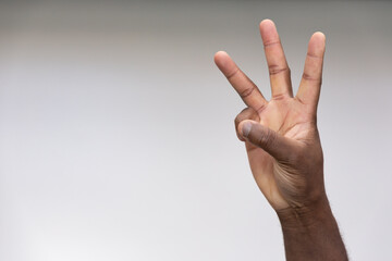 Hand of black African Man Pointing Up three fingers Gesture for number 3, Success, Goal, Direction concept on Isolated Background