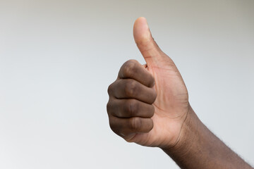 Hand of black African man pointing up approving thumb up hand gesture, concept of good, yes, acceptance, success, agreement, like, satisfaction