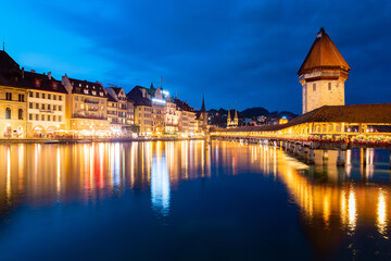 Night time panorama of Luzern old town in Switzerland. Colorfully illuminated waterfront of river...