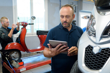 scooter senior mechanic checking details