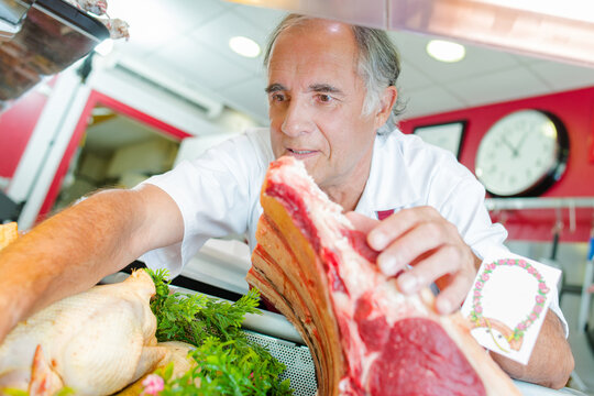 a butcher is searching for meat