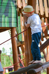 Obraz premium life of children in a modern city - little boy is having fun on the playground near the house