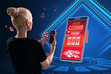 Online casino and gaming, gambling on device concept. Back view of blonde european woman and...