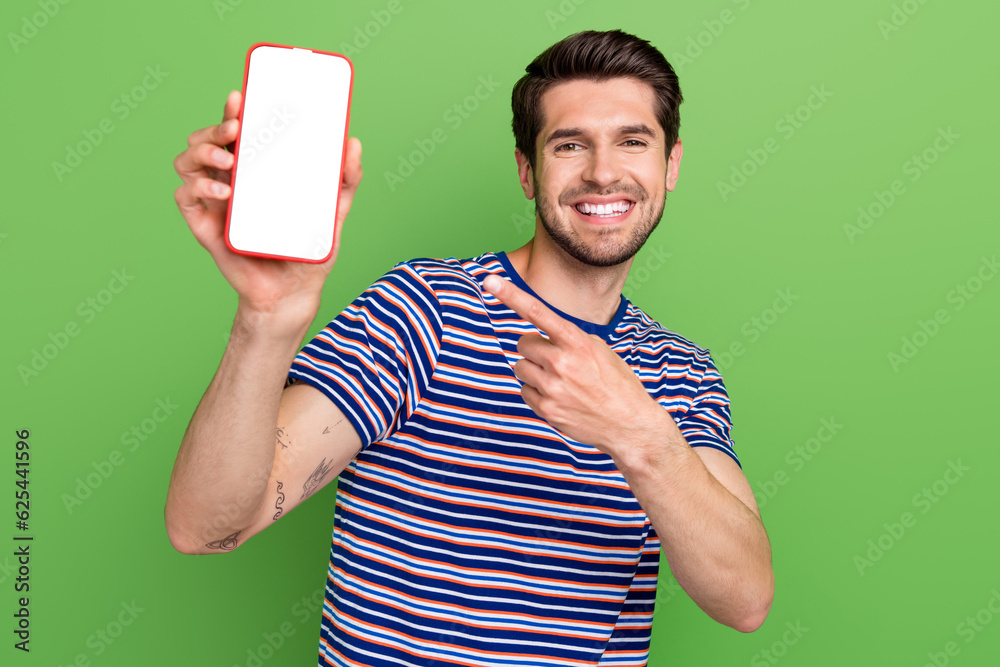 Canvas Prints Photo of attractive young promoter guy indicate finger smartphone digital display eshopping proposition isolated on green color background