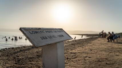 sign at dead sea lowest point on eath in jordan
