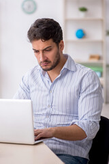 Young male employee working in the office