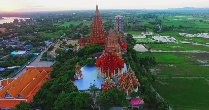 .Aerial view beautiful sunrise above Wat Tham Suea in Kanchanaburi Thailand. .Aerial view beautiful pagodas and Buddha statues built beyond the imagination of a temple built on top of a mountain..