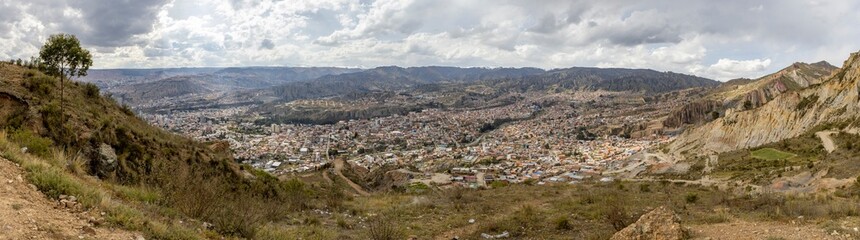 View from the scenic road to the landmark Muela del Diablo over the highest administrative capital, the city La Paz and El Alto in Bolivia - Panorama