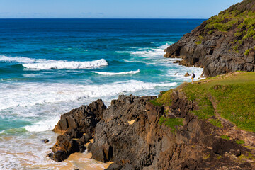 panorama of new south wales coast in hat head national park; green hills coverd with juicy grass by the ocean, beautiful beach surrounded by cliffs in australia, o'connors beach in hat head	