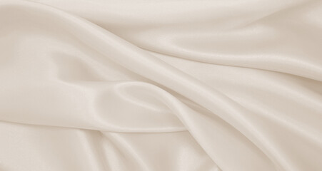 Smooth elegant golden silk or satin luxury cloth texture as wedding background. Luxurious Christmas...