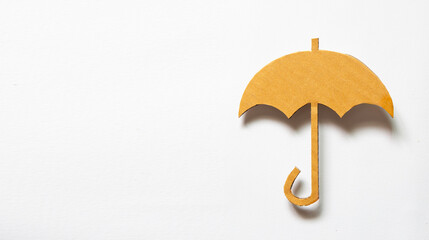 Cut out umbrella shape brown paper on white background with shadow and space for text. Minimal Fall and Winter Ideas