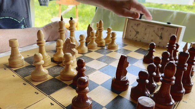 Active retirement, old friends and leisure, two senior men having fun and playing chess game at park. . High quality 4k footage