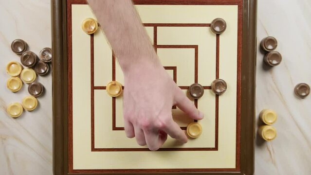 People Are Playing Nine Men Morris Board Game top view