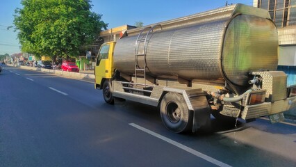 Water tanked truck crossing the urban street of urban area
