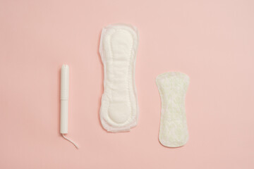 Different feminine sanitary napkins (sanitary pads) with tampon on pink background