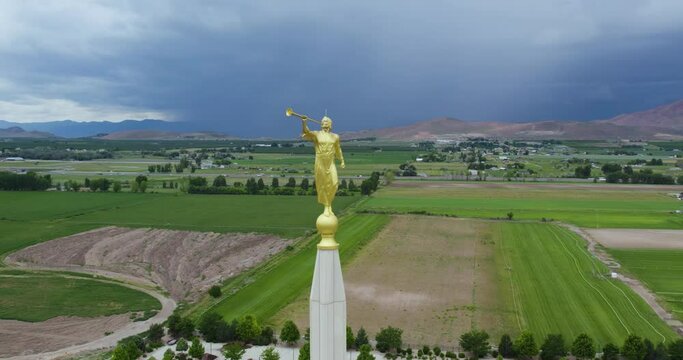 Symbolic Angel Moroni Statue Sculpture on LDS Mormon Temple in Payson, Utah - Aerial Drone Orbit with Lightning Thunderstorm