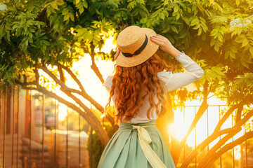 happy woman dancing spinning in vintage straw hat, girl long curly red hair fly wind, retro lady...