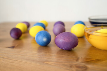 Obraz na płótnie Canvas Easter eggs on a wooden table, shallow depth of field.
