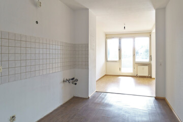 Empty renovated kitchen and dining room in a 1970s apartment with the original and outdated windows. Rental apartment during tenancy change over.