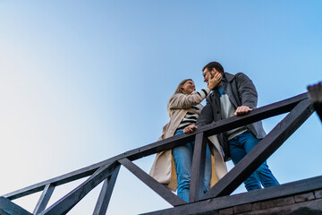 A portrait of a happy romantic couple walking outdoors in the surroundings of an old fortress