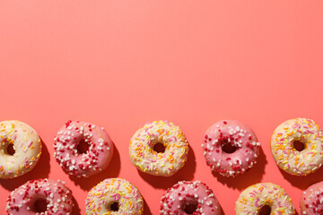 Glazed donuts on pink background, space for text