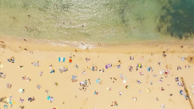 Aerial Top View Of Famous Maltese Beach, Golden Bay. People On The Beach. Malta 