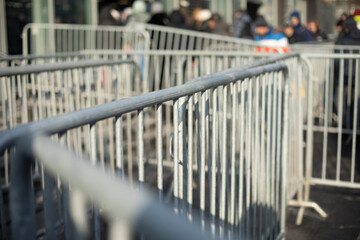 Fence at public event. Grey fence to block crowd. Steel frame.