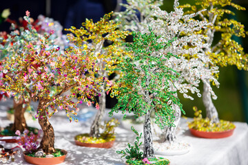 Handcrafted beaded trees for sale at the handicraft fair.