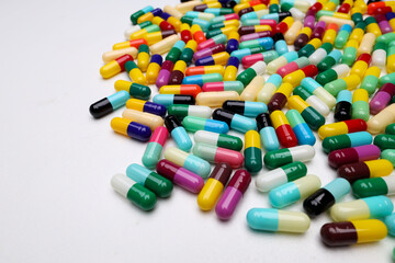 colored pill capsules placed on a white background