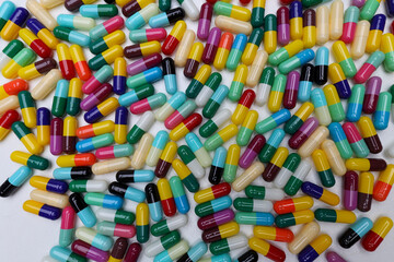 colored pill capsules placed on a white background