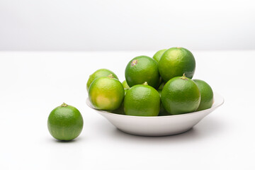 fresh lemons on plate on a white background