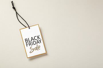 Black friday sale tag with gold border on beige background