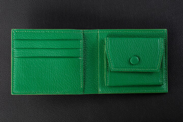 Leather products. Green leather purse on a black background.
