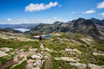 Naklejka premium Young hiker girl summit to Ratera Peak in Aiguestortes and Sant Maurici National Park, Spain
