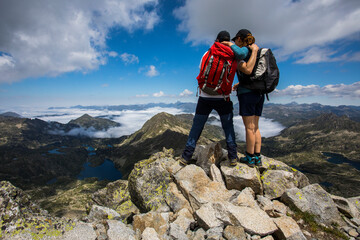 Young hiker couple in Ratera peak, Aiguestortes and Sant Maurici National Park, Spain - obrazy, fototapety, plakaty