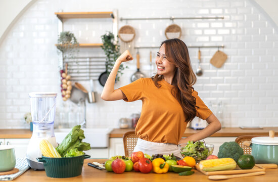 Portrait of beauty body slim healthy asian woman having fun cooking and preparing vegan food healthy eat with fresh vegetable salad, vegetarian on counter in kitchen at home.Diet.Fitness, healthy food