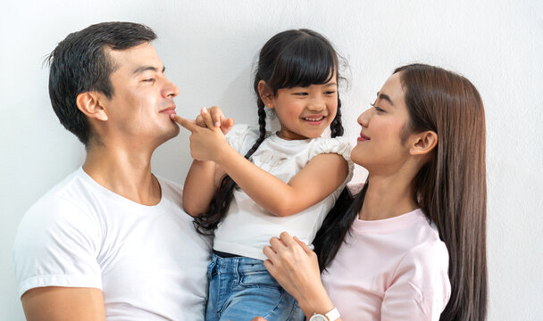 Portrait of enjoy happy love asian family father and mother holding hug cute little asian girl child smiling play and having fun moments good time, care, kid, support, insurance, child, at home