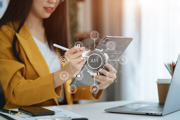 Modern technology and networking concept, woman using laptop, tablet and smartphone with virtual screen API icon Software development tool. API Application Programming Interface.