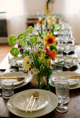 serving the table with fresh flowers and candles