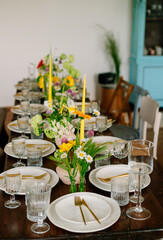 serving the table with fresh flowers and candles