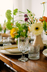 serving the table with fresh flowers and candles