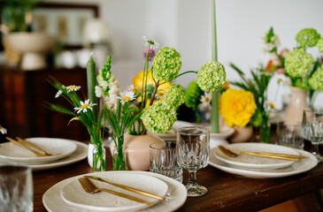 serving the table with fresh flowers and candles