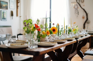 serving the table with fresh flowers and candles