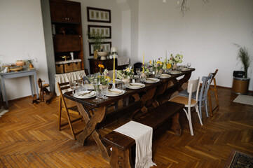 serving the table with fresh flowers and candles