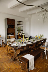 serving the table with fresh flowers and candles